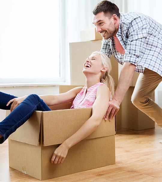 man pushing woman in moving box